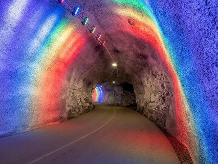 Colorful illuminated tunnel for bicycles and pedestrians leads up to Hardanger suspension bridge,