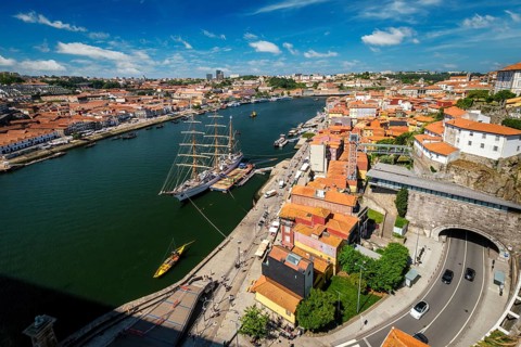 Aerial view of Porto city and Vila Nova de Gaia and Douro river with moored sailling ship from Dom