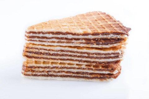 Waffle sandwiches with boiled condensed milk isolated on white background. closeup
