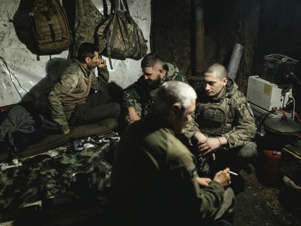 Iura, Volodymyr, Daniel and Ruslan wait with a 122 mm artillery gun from Soviet stocks for the