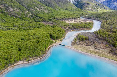 Aerial view of lake Lago Jeinimeni, river flowing out of the lake, glacial blue water in contrast