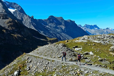 Two hikers on a narrow hiking trail in the hiking region of Kandersteg, Kandertal, Bernese