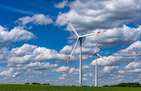 Wind farm, wind turbine, wind turbines from the manufacturer Enercon, blue sky with many white