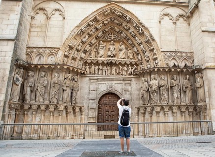 Castilian man photographing the portal of the Cathedral of Santa Maria of Burgos, historic centre,