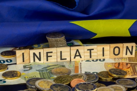 Symbolic image of inflation (in the euro area) : The word INFLATION in letter cubes on euro coins