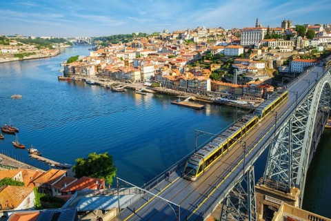 View of Porto city and Douro river and Dom Luis bridge I with metro tram from famous tourist