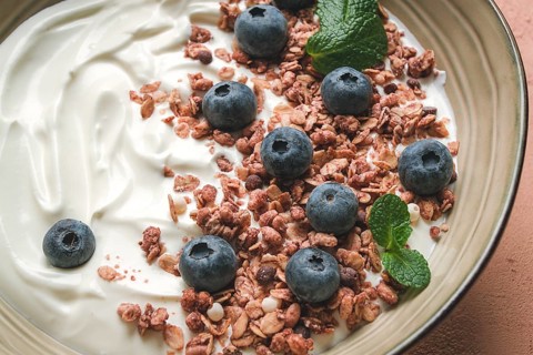 Yogurt with chocolate muesli, with berries, blueberries, breakfast, close-up, fork on top, no