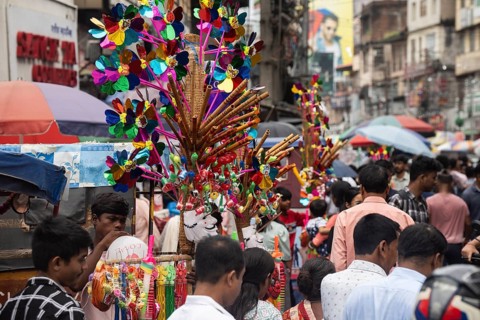 Vendor sells toys and other children items at a street market ahead of Durga Puja festival on