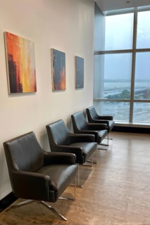 Minimalist styled waiting room with an ordered row of chairs lined up, AI generated