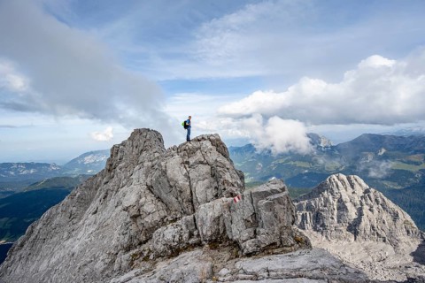 Mountaineer on a narrow rocky ridge, Watzmann crossing to Watzmann Mittelspitze, view of mountain