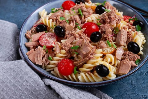 Fusilli pasta salad with canned tuna, cherry tomatoes and olives, parmesan, microgreens, homemade,