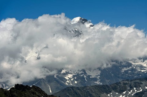 Combin du Valsorey in the Grand Combin massif looks out of the clouds, Valais, Switzerland, Europe