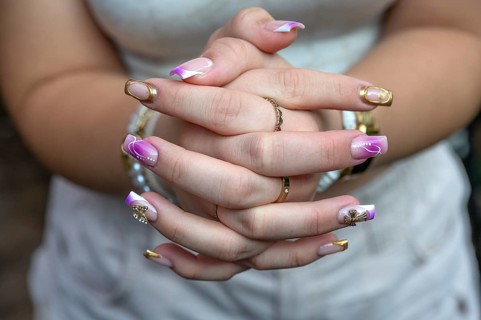 Colourful fingernails of a young woman, Baden-Württemberg, Germany, Europe