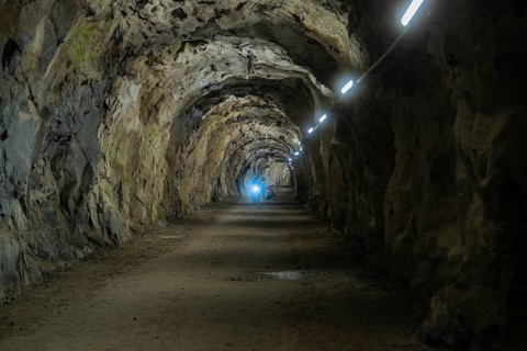 Dark tunnel with illuminated stone walls and a mysterious atmosphere, Klein Tibet, Zillertal,