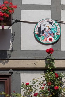 Schützenfest plaque on house wall, flowers, half-timbered house, Hildesheim, Lower Saxony, Germany,