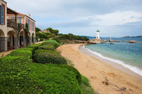 Lighthouse with beach and colourful houses, Spiaggia Porto Faro, Faro di Punta Palau, Palau, Costa