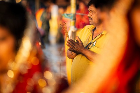 Hindu devotees perform rituals as they offer prayers to the Sun god in the bank of Brahmaputra
