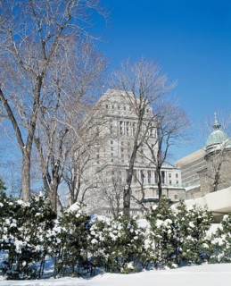 Sunlife insurance building through park in winter, Montreal, Quebec, Canada, North America