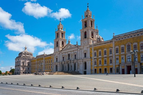 Large square in front of a baroque palace with magnificent architecture under a clear sky, National