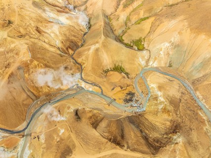 Steaming hot springs and colourful rhyolite mountains, aerial view, Hveradalir geothermal area,