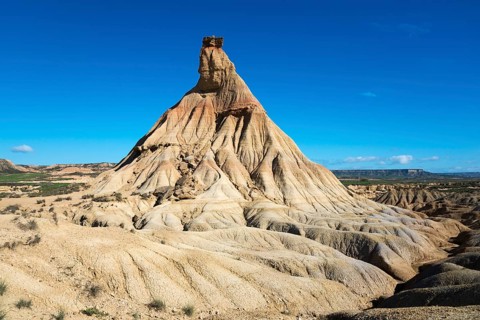 A stony natural monument in an arid desert environment under a blue sky, Castildetierra, Bardenas