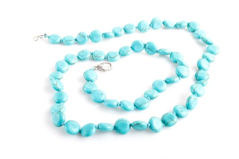 Blue semiprecious stone beads isolated on white background. top view, close up