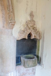Holy water stoup bowl in porch entrance, village parish church of St James South Elmham, Suffolk,