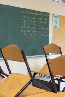 Classroom of a fourth grade, after school, the building is older but in good condition, timetable