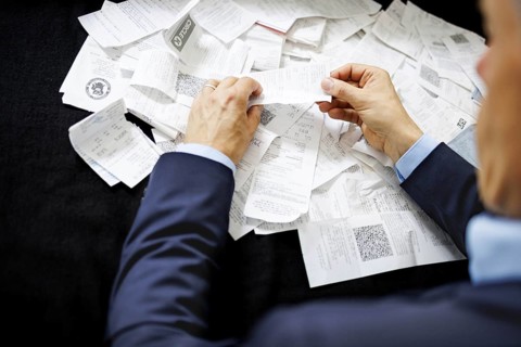 The subject of taxes. A man holds receipts in his hand in Berlin, 09/08/2024