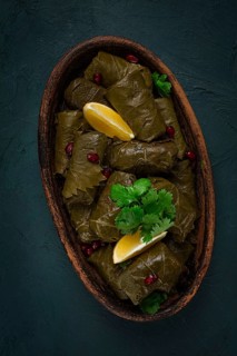 Dolma (Tolma) stuffed rolls, minced meat with rice, in grape leaves, top view, no people, close-up