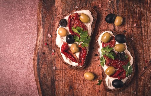 Breakfast, sandwiches, with cream cheese, olives, top view