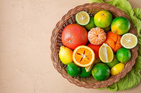 Assortment, citrus fruits, in a basket, close-up, top view, no people