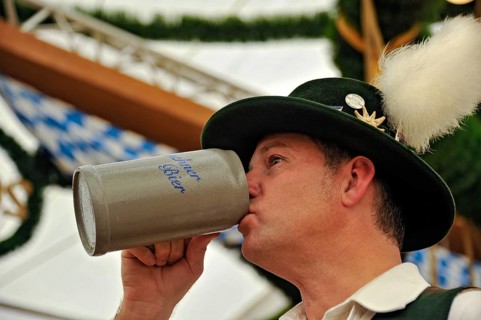 Man in traditional Bavarian traditional costume drinking beer from a beer mug, beer mug, old