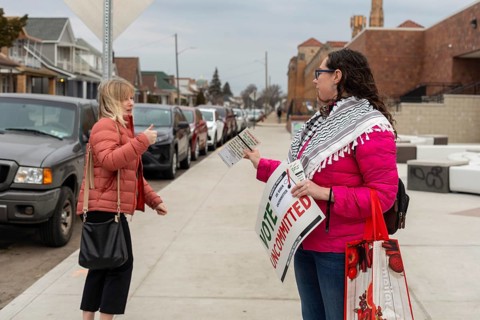 Hamtramck, Michigan USA, 27 February 2024, Lindsey Matson urges people arriving to vote in