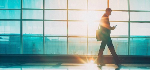 Passenger businessman in modern international airport waiting for plane departure, AI generated