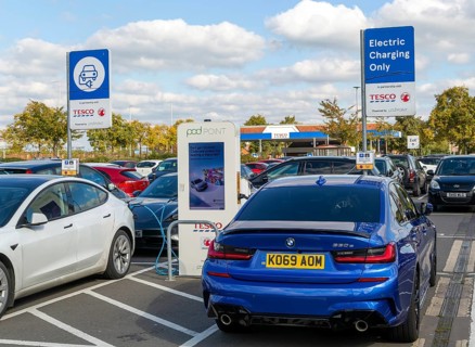 Electric vehicles charging Pod Point, Tesco Extra supermarket carpark, Swindon, Wiltshire, England,