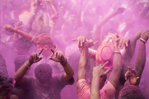 Revellers dancing in the beat of music as they celebrate Holi on a street, the Hindu spring