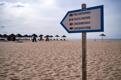 Sandy beach beach sign, guarded, concession beach, multilingual, Portuguese, French, English,