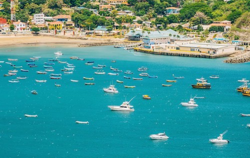 A beautiful bay with yachts and boats on the shore. Boats and yachts in the bay of San Juan del Sur