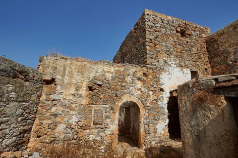 Abandoned stone houses and ruins under a clear blue sky on a sunny day, Venetian Sea Fortress,