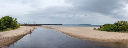 Wide beach with shallow waters and cloudy skies, Ballycastle