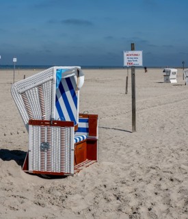 Beach chairs and signs on the sandy beach of the North Sea, Sankt Peter-Ording, Schleswig-Holstein,