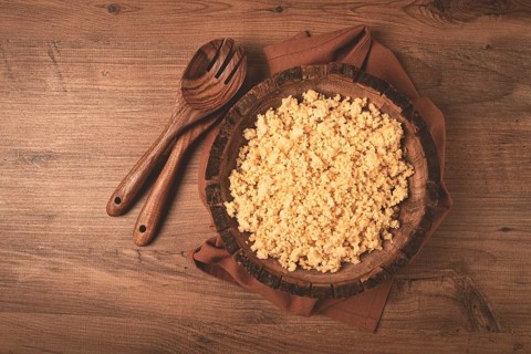 Cooked couscous, in a wooden bowl, top view, no people
