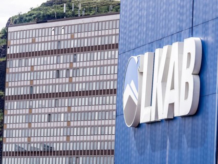 LKAB mining area, large LKAB company sign on building, company symbol, mining tower in the back,
