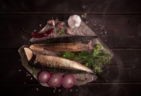 Smoked mackerel, top view, with spices, on a wooden table, no people, selective focus