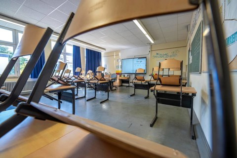 Classroom of a fourth grade, after school, the building is older but in good condition, modern