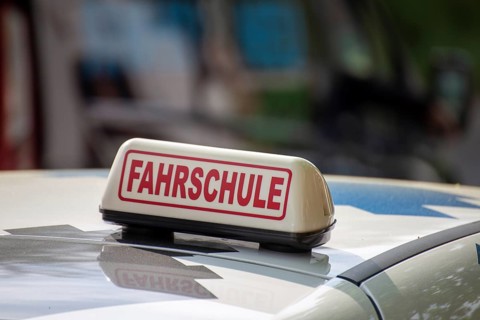 Close-up of a driving school sign in Germany