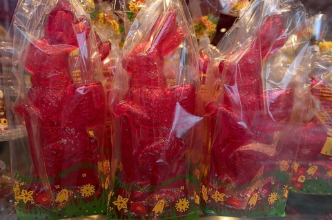 Red rabbit figurines wrapped in cellophane, in the shop window of a confectionery, Bavaria,