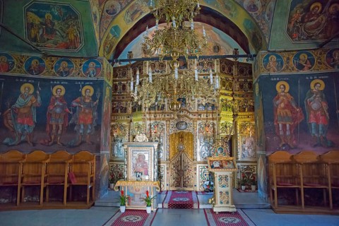 Interior view of an Orthodox church with richly decorated iconostasis and murals, Cheia Romanian
