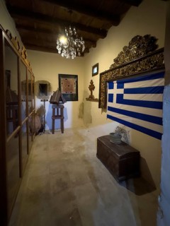 Chamber room with festive chandelier chandelier right Greek national flag flag of Greece in